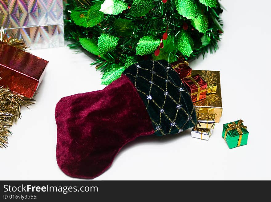 Christmas scene with focus on a pretty stocking bursting with presents. Christmas scene with focus on a pretty stocking bursting with presents.