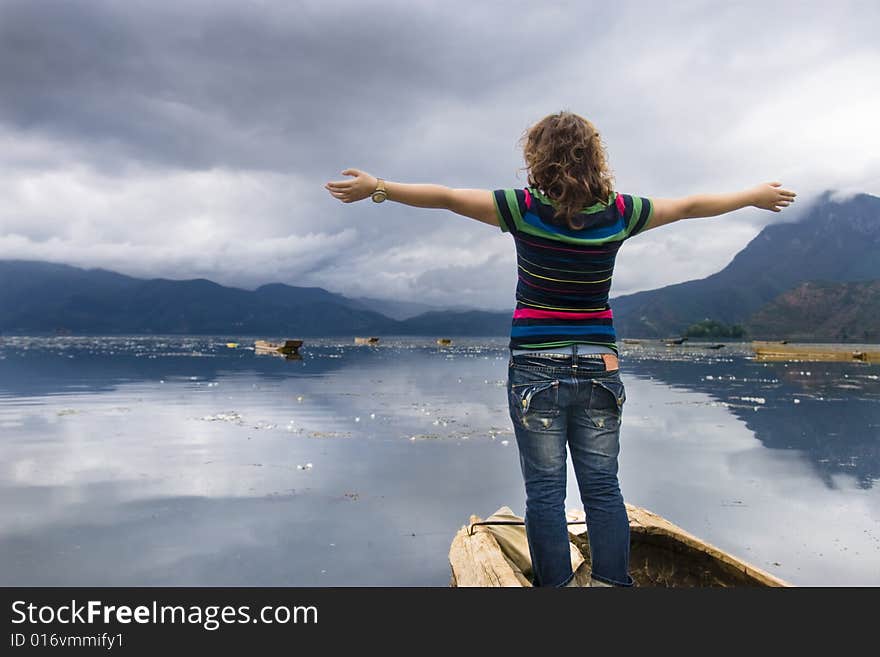 A girl standing on the shore of the lake. A girl standing on the shore of the lake