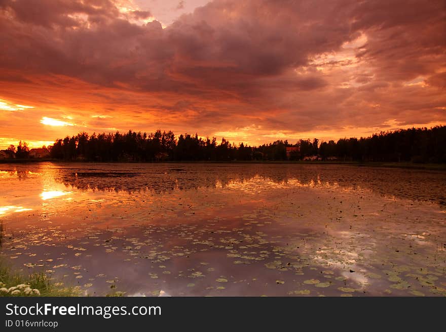 Lake at sunset with reflection in Finland