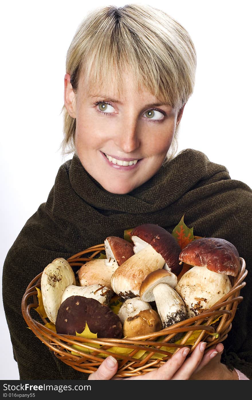 Young blond woman holding mushrooms close up