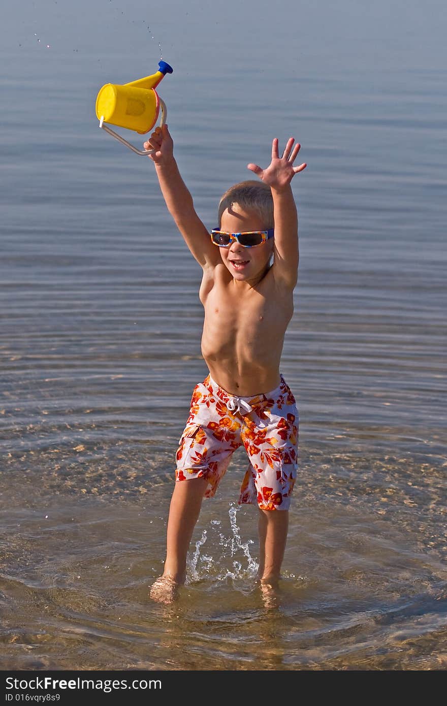 Boy carrying  waterbucket