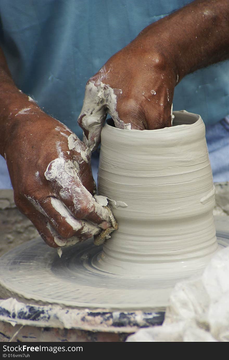 A artist forms a vase during Mumfest in New Bern, NC. A artist forms a vase during Mumfest in New Bern, NC