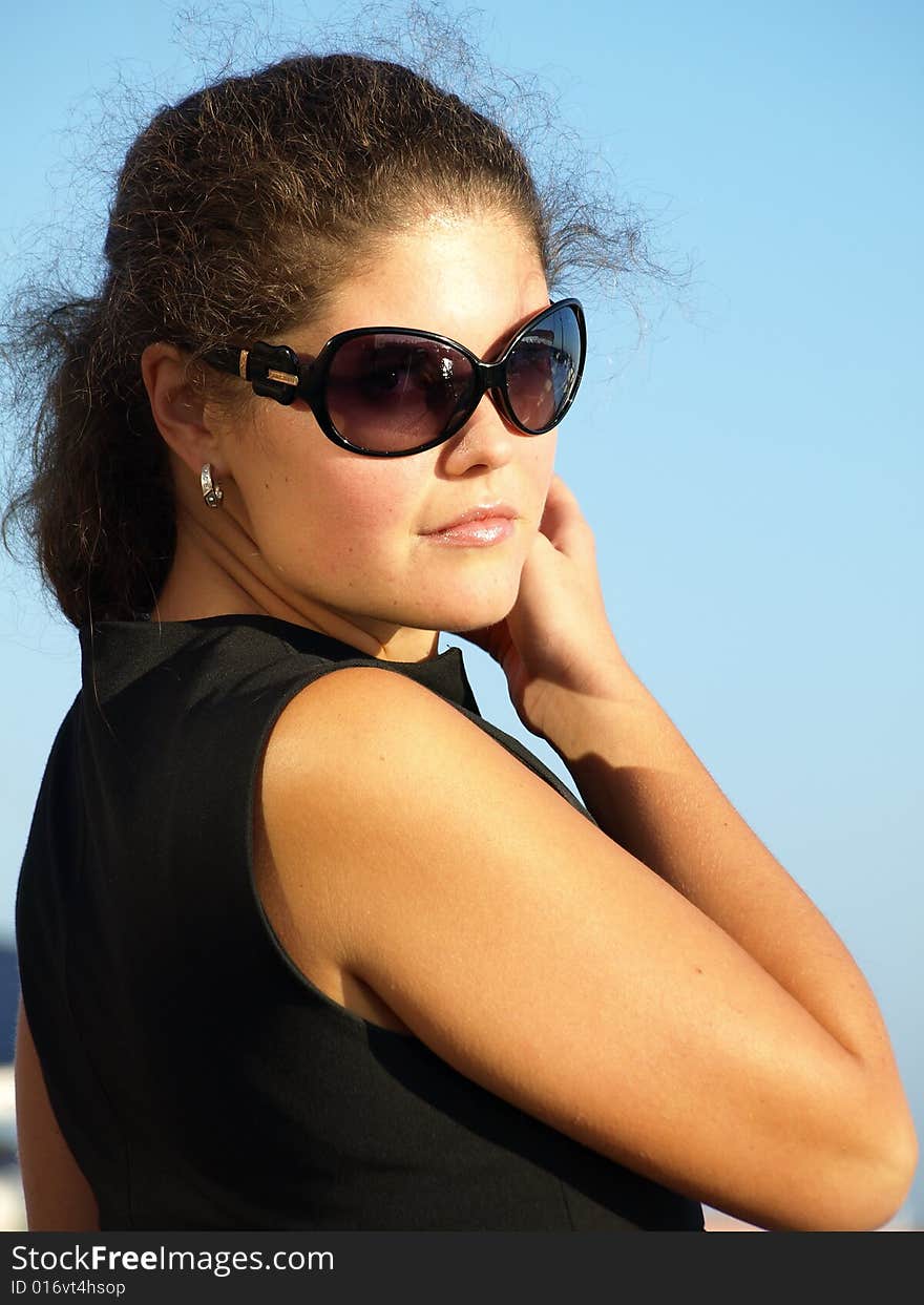 Attractive young woman wearing sunglasses. Attractive young woman wearing sunglasses