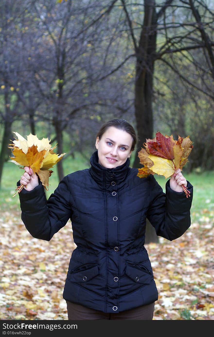 Girl in a park keeps fallen leaves. Girl in a park keeps fallen leaves