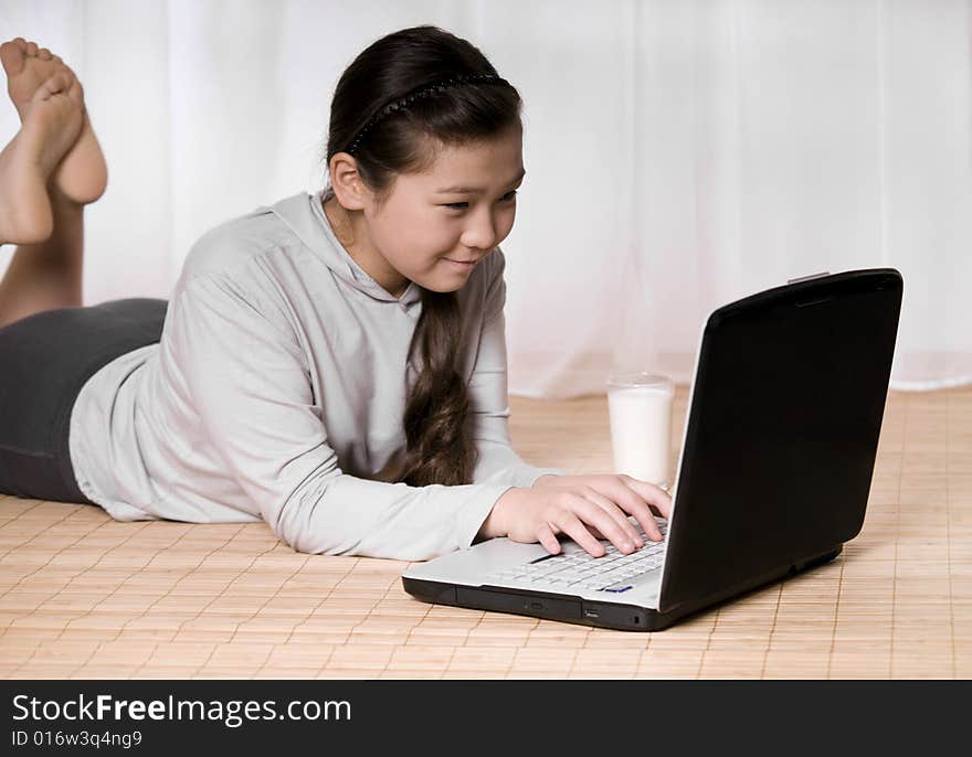 Teenager girl with notebook and glass milk