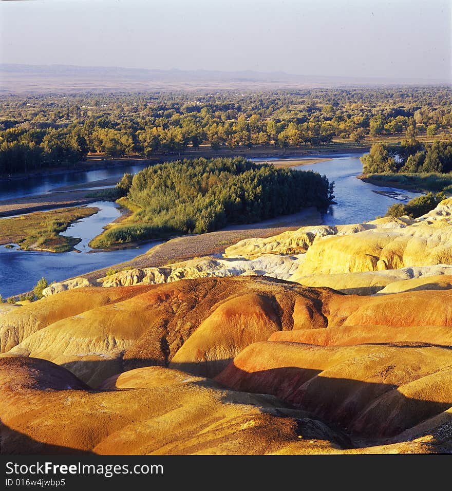 A river with forest and red rock on sides