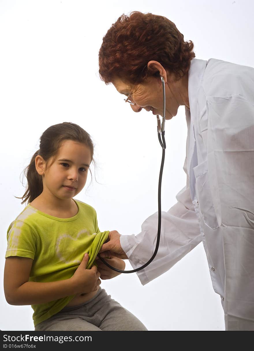 Senior women doctor examining a young girl patient. Senior women doctor examining a young girl patient