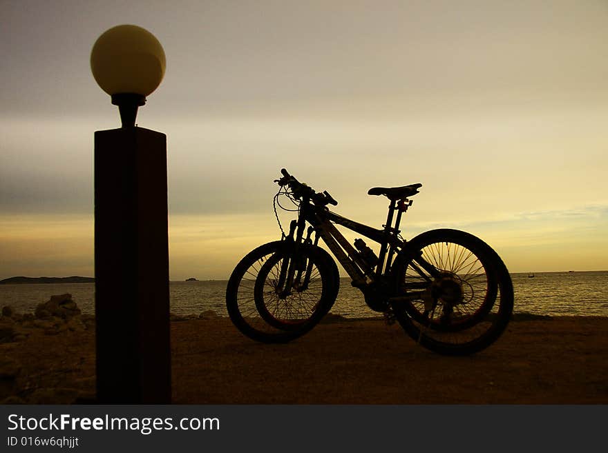 Bicycles on the evening beach and sundown. Bicycles on the evening beach and sundown