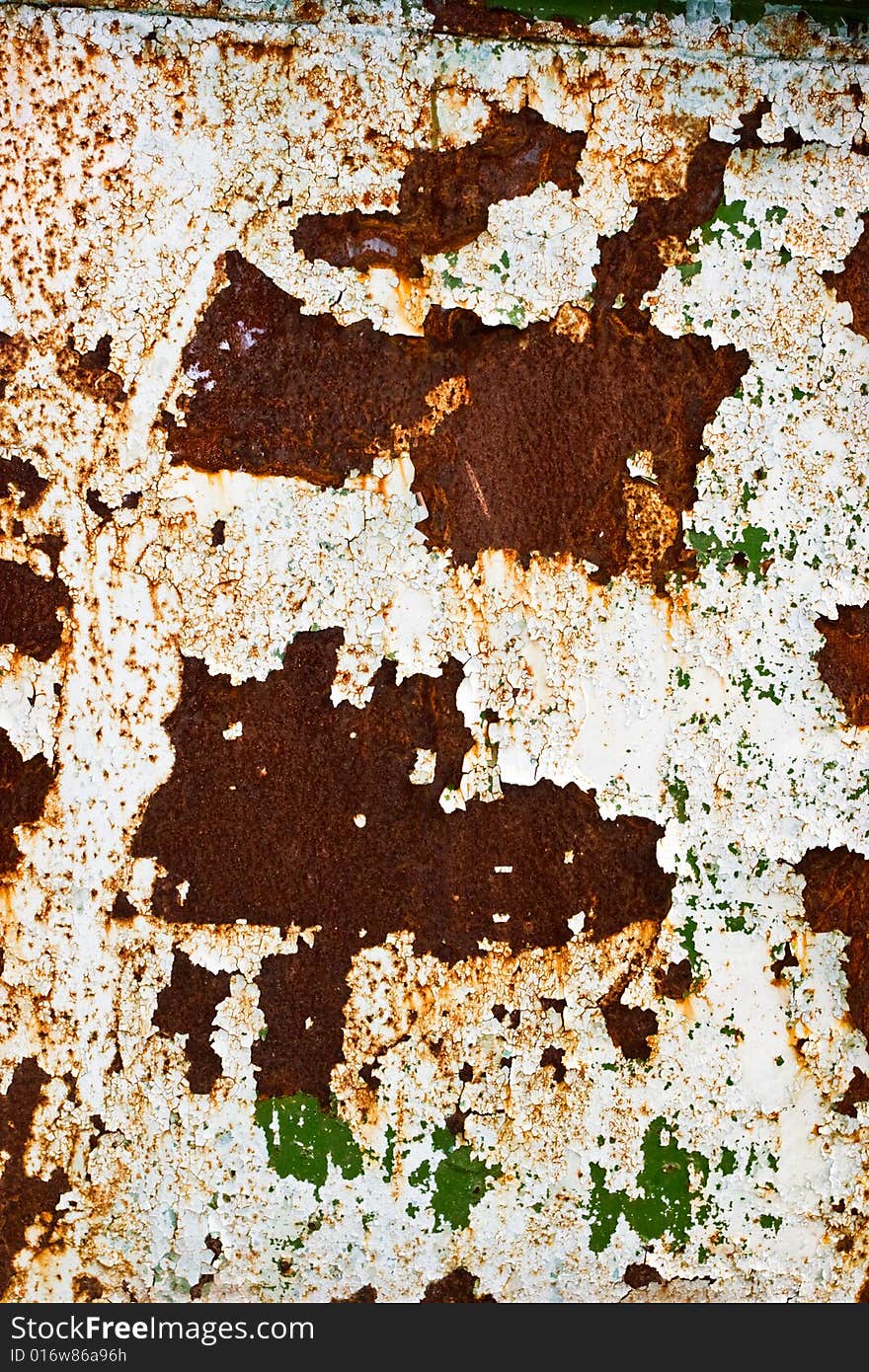 White and green peeling paint on rusty steel wall. White and green peeling paint on rusty steel wall