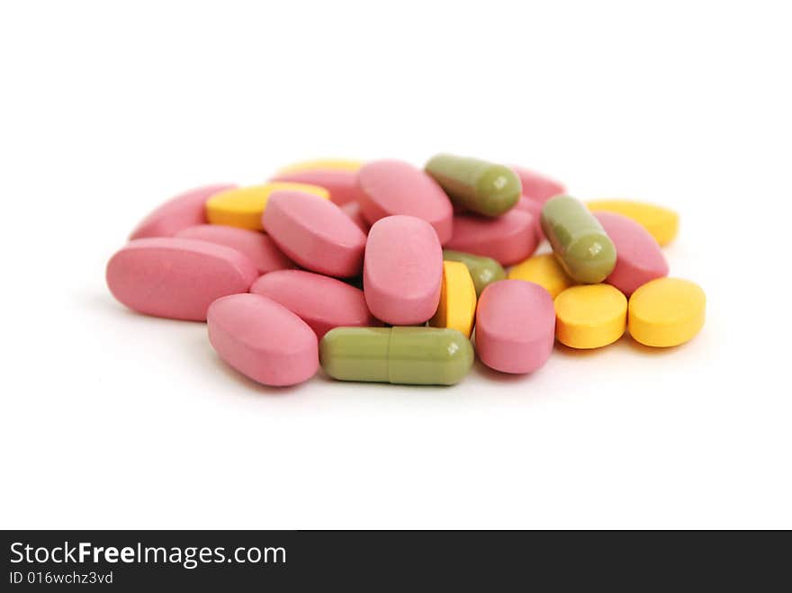 Colourful pills isolated on white backgrounder