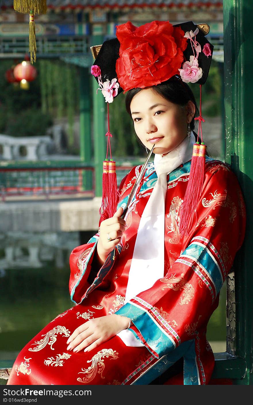 A beautiful girl in Chinese ancient dress is in the royal garden. This is dress of Qing Dynasty of China. It is the princess' dress too. A beautiful girl in Chinese ancient dress is in the royal garden. This is dress of Qing Dynasty of China. It is the princess' dress too.