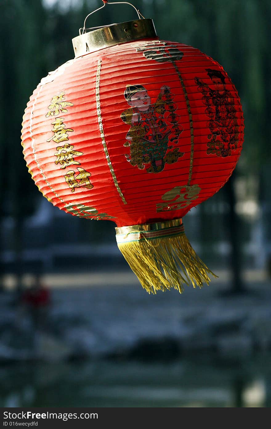 Red lantern on the ancient garden long corridor of China. Chinese on the lantern is lucky and getting rich. Red lantern on the ancient garden long corridor of China. Chinese on the lantern is lucky and getting rich.