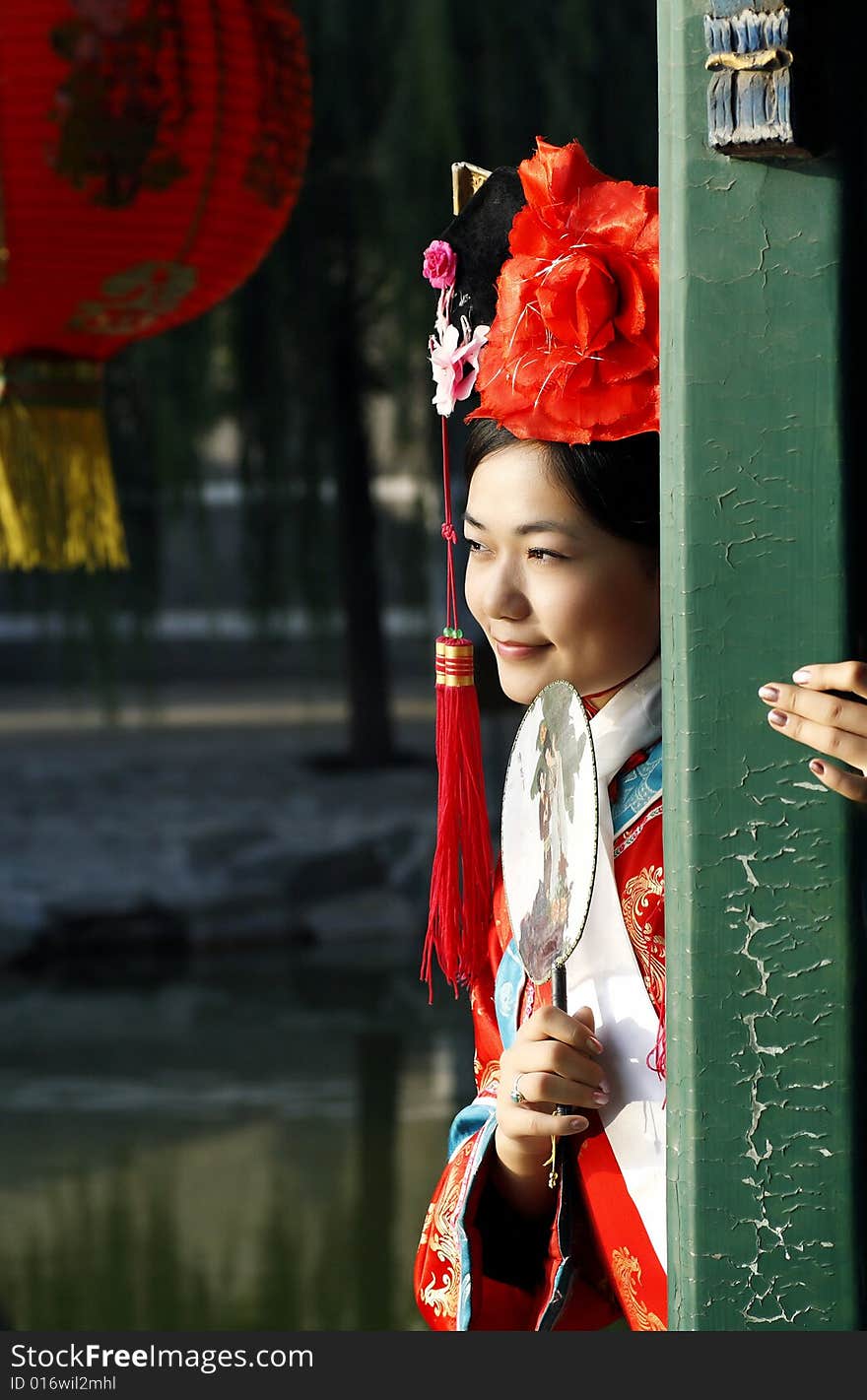 A beautiful girl in Chinese ancient dress is in the royal garden.This is dress of Qing Dynasty of China. It is the princess' dress too. It is a New Year picture of China to draw on the lantern. Chinese on the fan is meant and missed. A beautiful girl in Chinese ancient dress is in the royal garden.This is dress of Qing Dynasty of China. It is the princess' dress too. It is a New Year picture of China to draw on the lantern. Chinese on the fan is meant and missed.