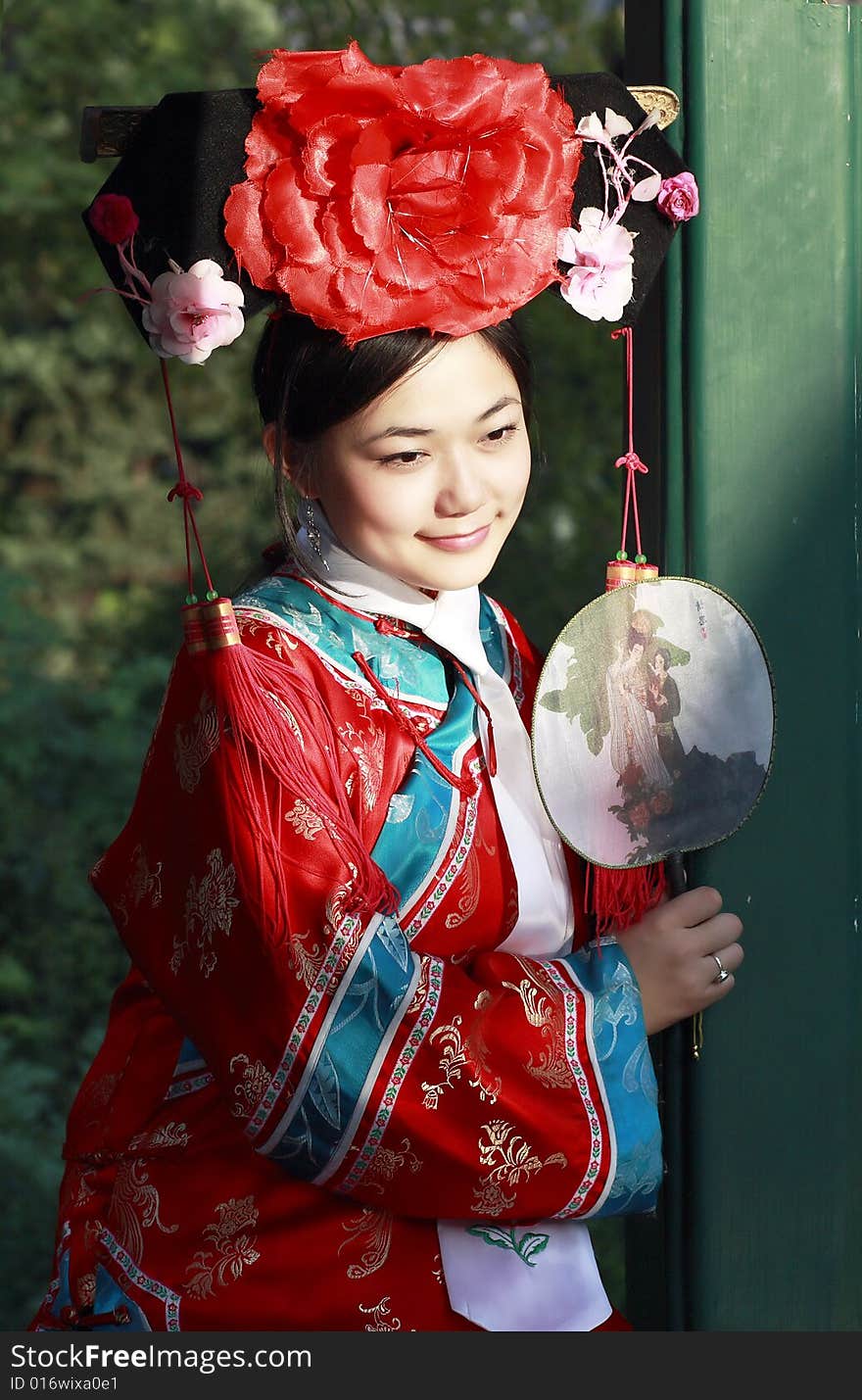 Portrait of a beautiful girl in Chinese ancient dress. 

 This is dress of Qing Dynasty of China. It is the princess' dress too.

Chinese on the fan is meant and missed. Portrait of a beautiful girl in Chinese ancient dress. 

 This is dress of Qing Dynasty of China. It is the princess' dress too.

Chinese on the fan is meant and missed.