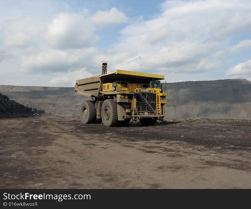 Dump truck carries coal on cut