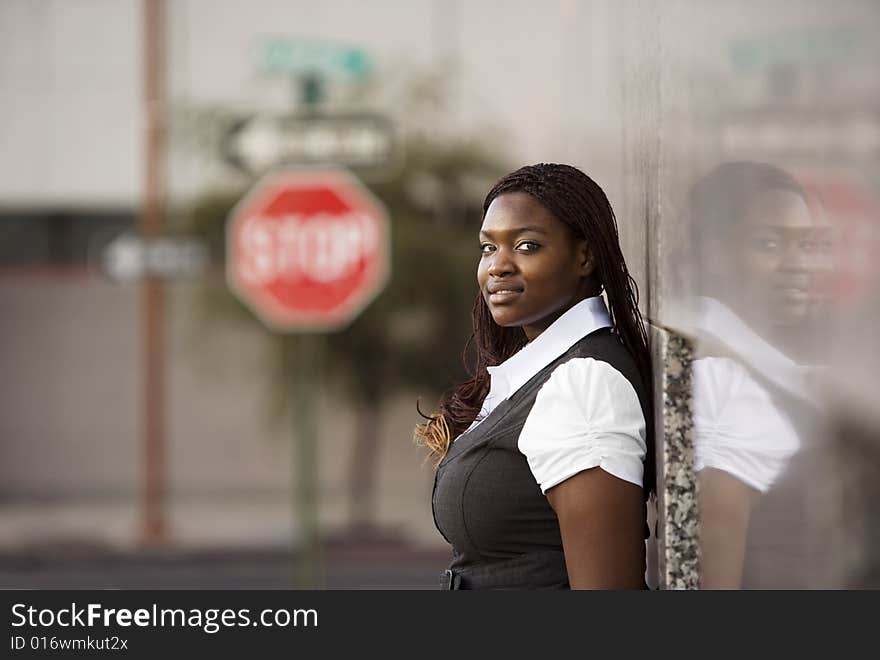 African American Woman Leaning Against A Building