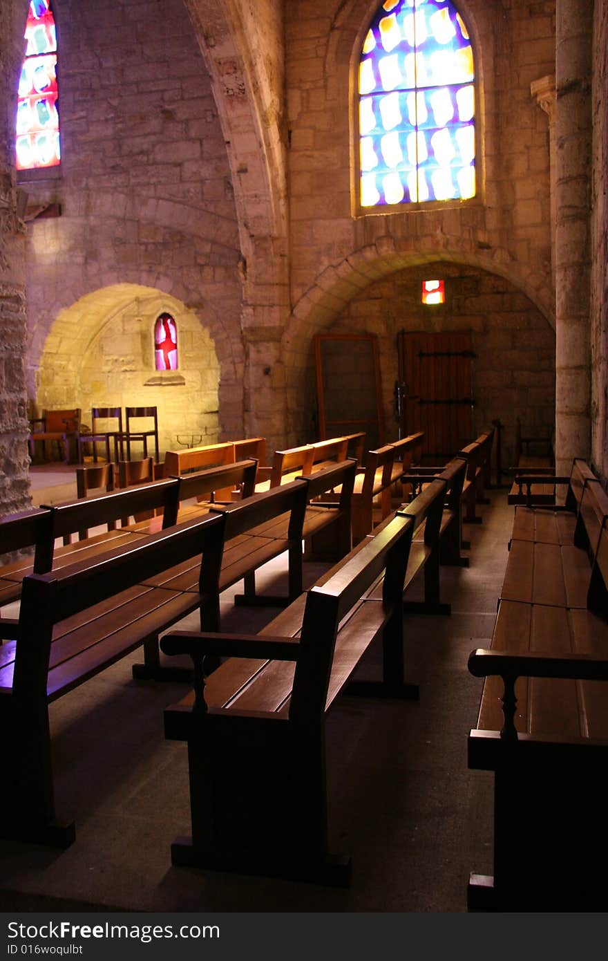 Warm light on the benches in a small church, Aigues Mortes, France. Warm light on the benches in a small church, Aigues Mortes, France.