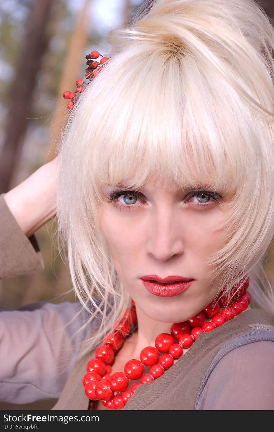 Portrait of a pretty girl wearing red beads. Portrait of a pretty girl wearing red beads