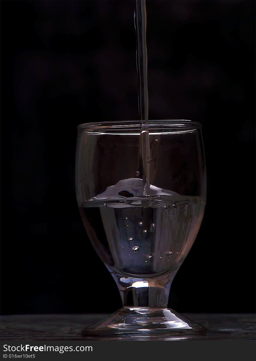 Water is dropping into glass with bubble. Water is dropping into glass with bubble