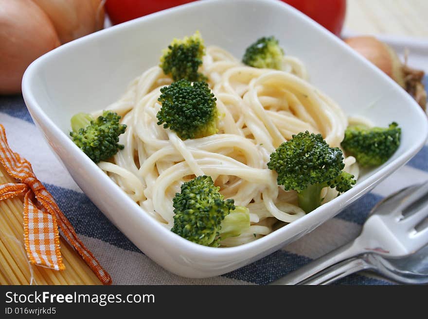 Italian noodles with cheese sauce and broccoli. Italian noodles with cheese sauce and broccoli