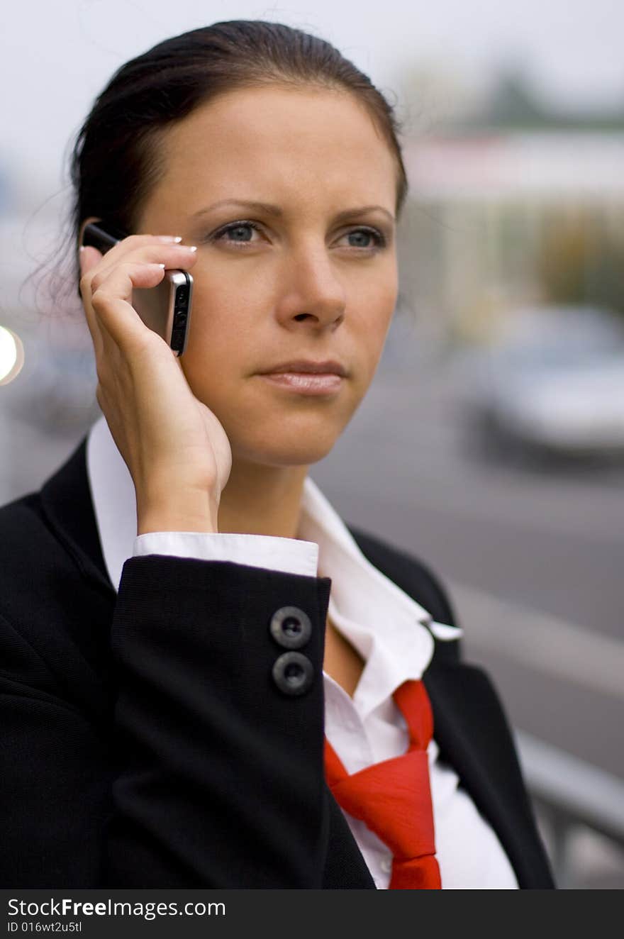 Pretty businesswoman talking by mobile phone