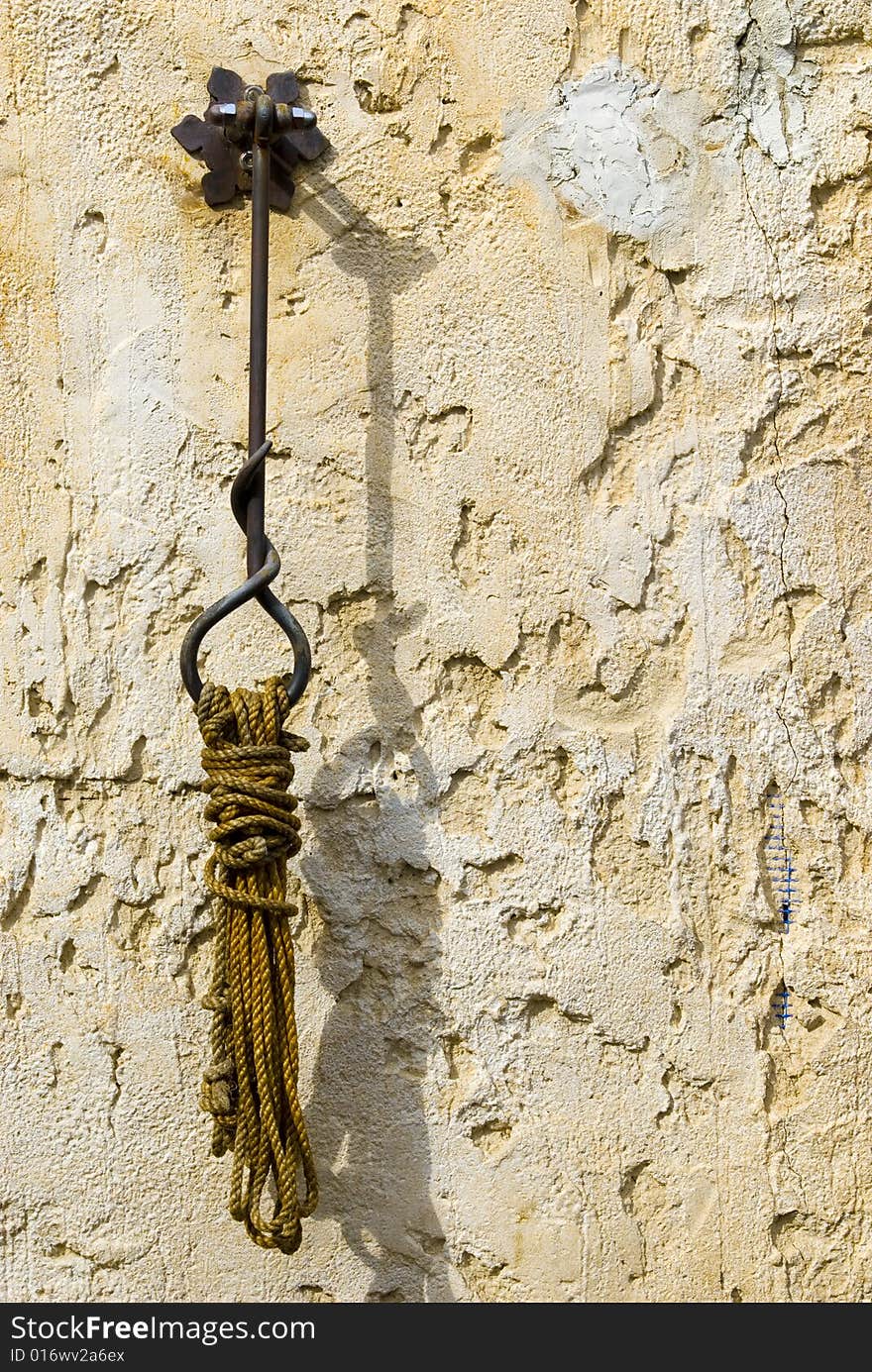 A shot of a rope which is hanging form a handcrafted hook. A shot of a rope which is hanging form a handcrafted hook