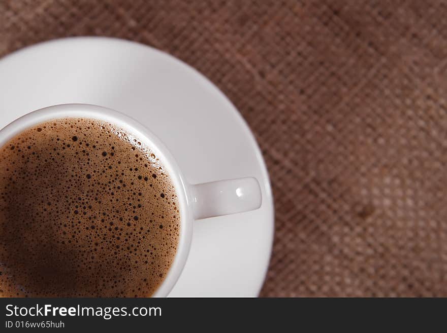 Closeup of  black coffee cup on hessian background