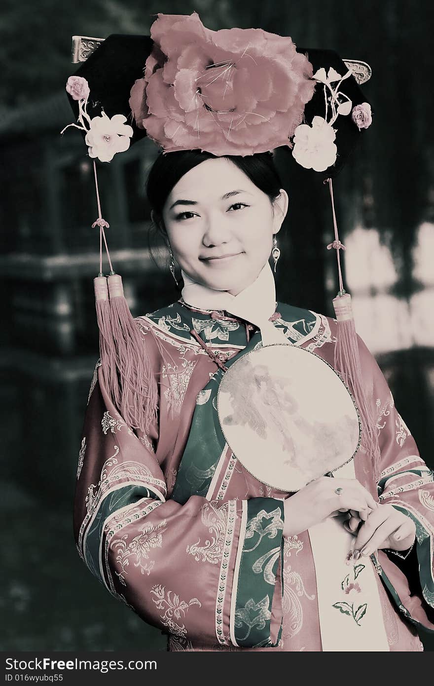 Portrait of a beautiful girl in Chinese ancient dress. 
Chinese on the fan is meant and missed. Portrait of a beautiful girl in Chinese ancient dress. 
Chinese on the fan is meant and missed.