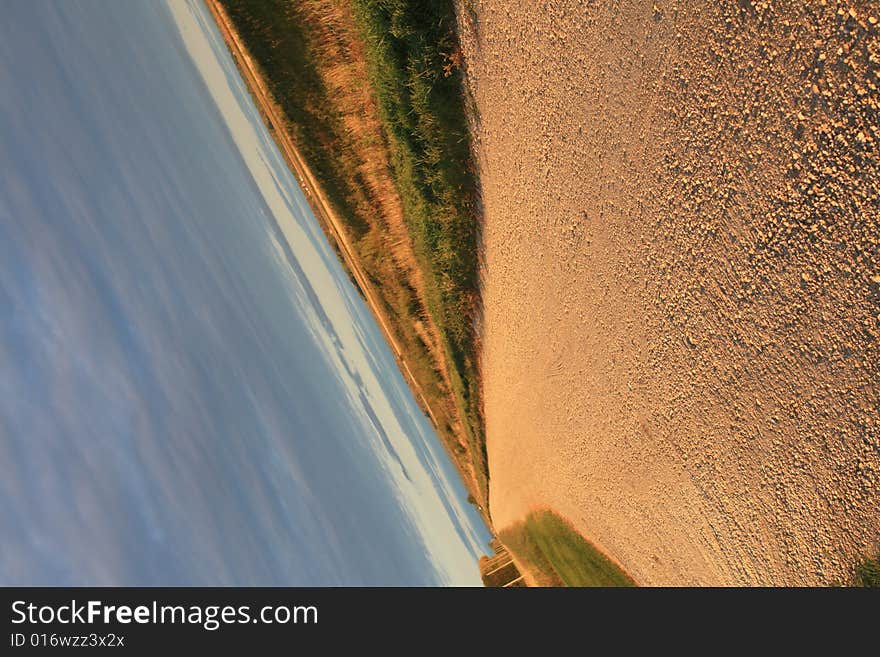 Slanted view of a gravel road.