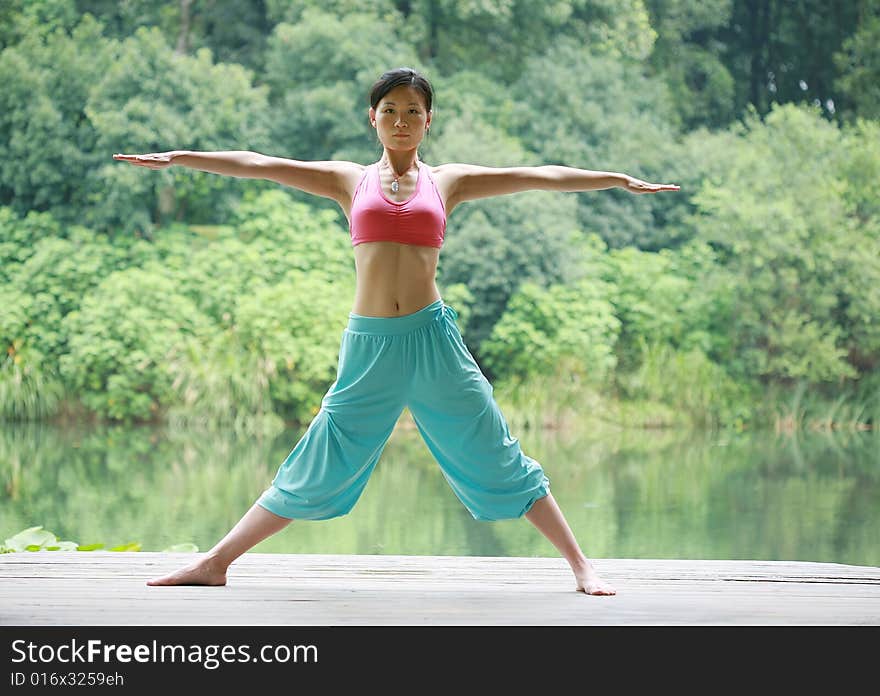 A young chinese woman practicing yoga in the outdoors. A young chinese woman practicing yoga in the outdoors