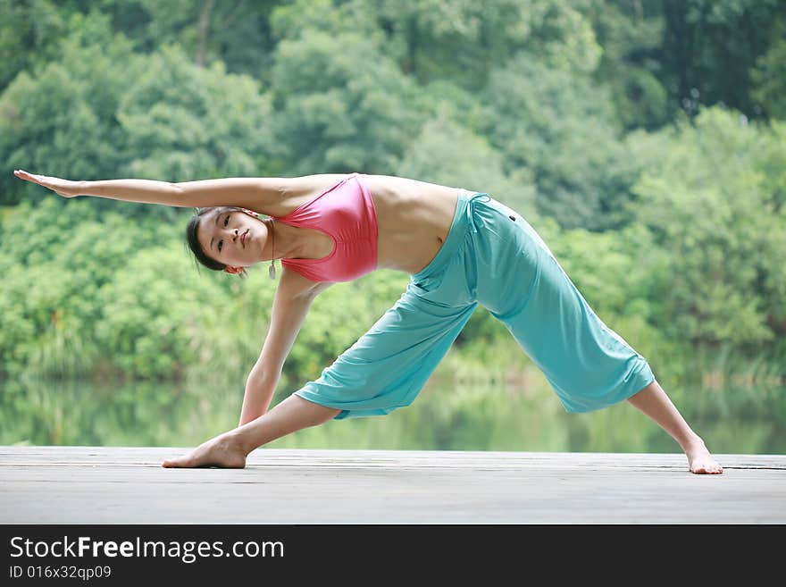 Young chinese woman practicing yoga outdoor