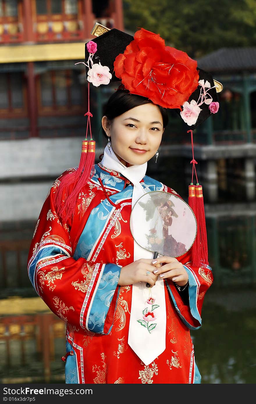 Portrait of a beautiful girl in Chinese ancient dress. 

Chinese on the fan is meant and missed. Portrait of a beautiful girl in Chinese ancient dress. 

Chinese on the fan is meant and missed.