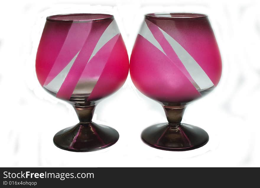 Two pink glasses on a white background