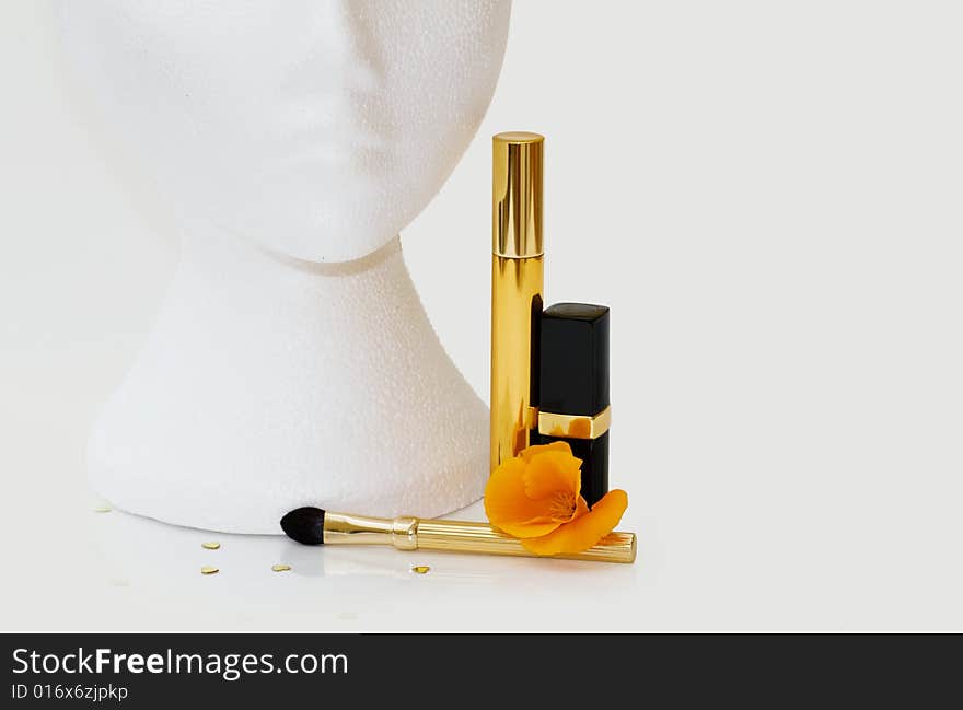 Female mannequin with lipstick, mascara and makeup brush. Clipping path and copy space included. Female mannequin with lipstick, mascara and makeup brush. Clipping path and copy space included.