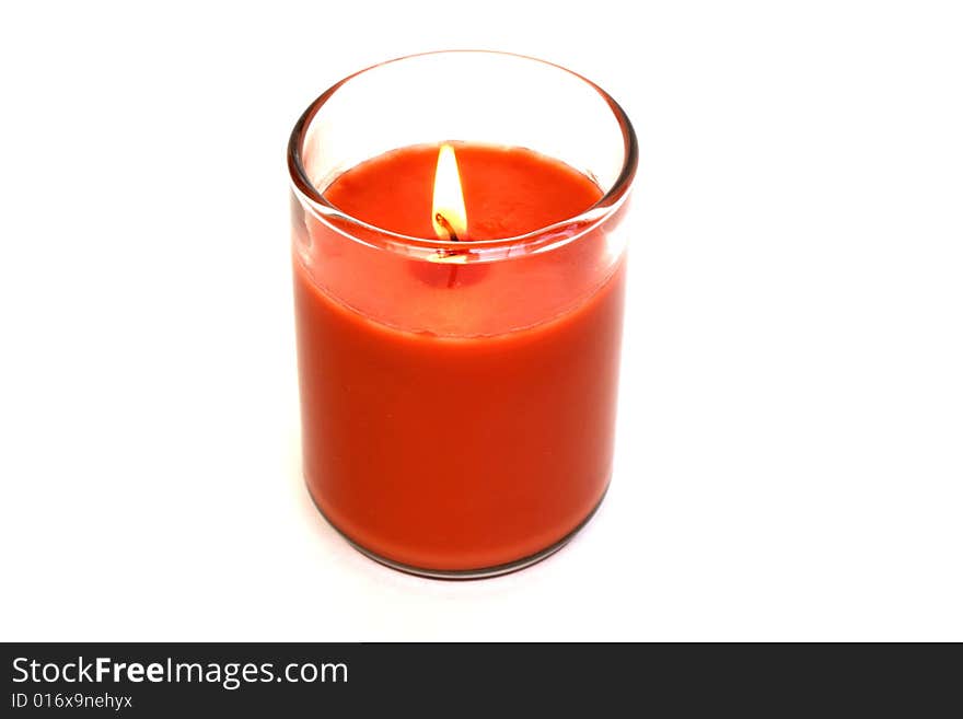 Orange candle with a vibrant flame