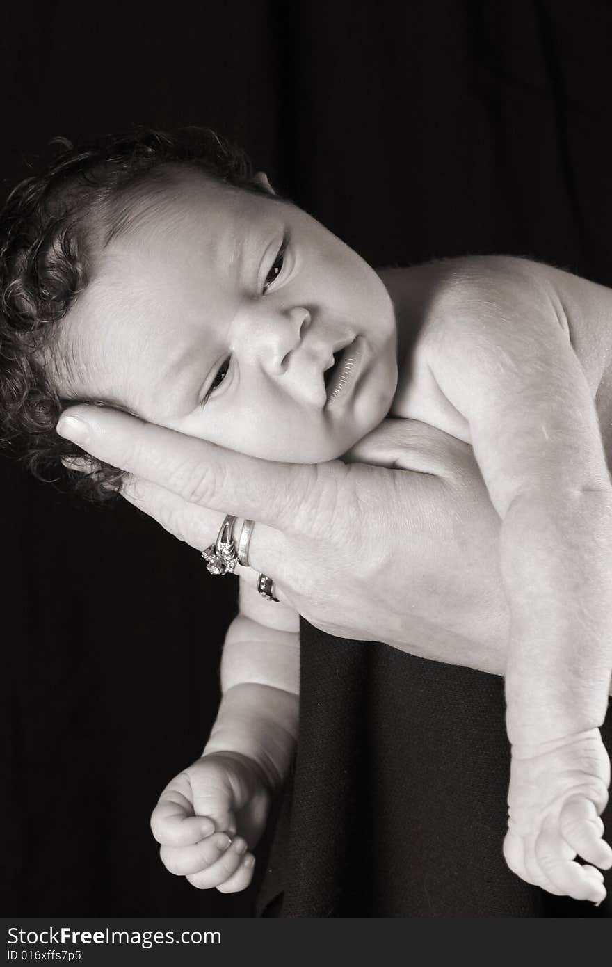 Little baby with a head full of hair on mommy's hand. Little baby with a head full of hair on mommy's hand