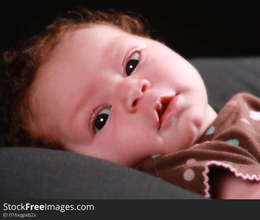 One week old baby girl with her eyes wide open