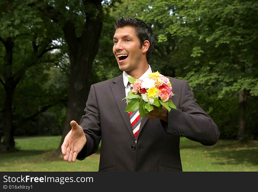 Man giving hand with a bouquet of flowers outdoor. Man giving hand with a bouquet of flowers outdoor