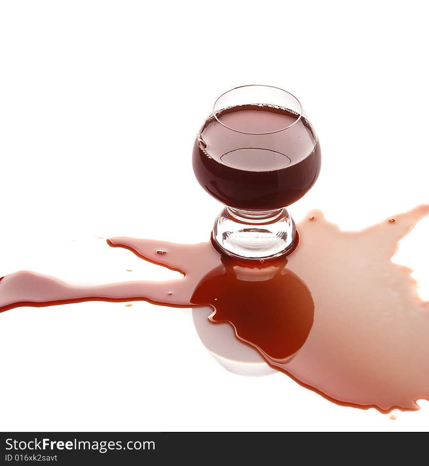 The spilled red wine. Wine poured on a surface, is isolated on a white background