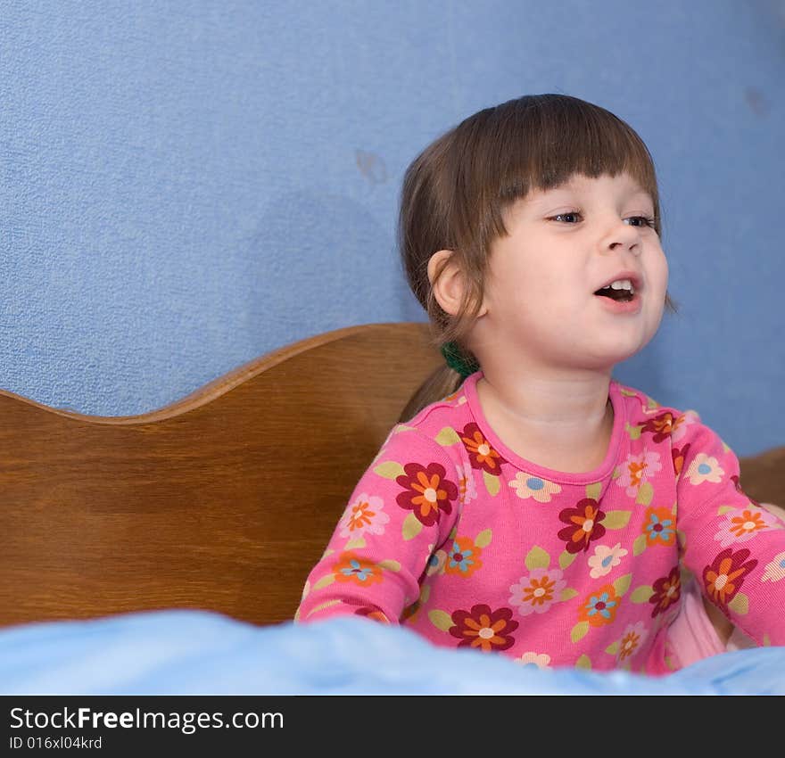 The little girl on a bed. The three-year child of the European nationality