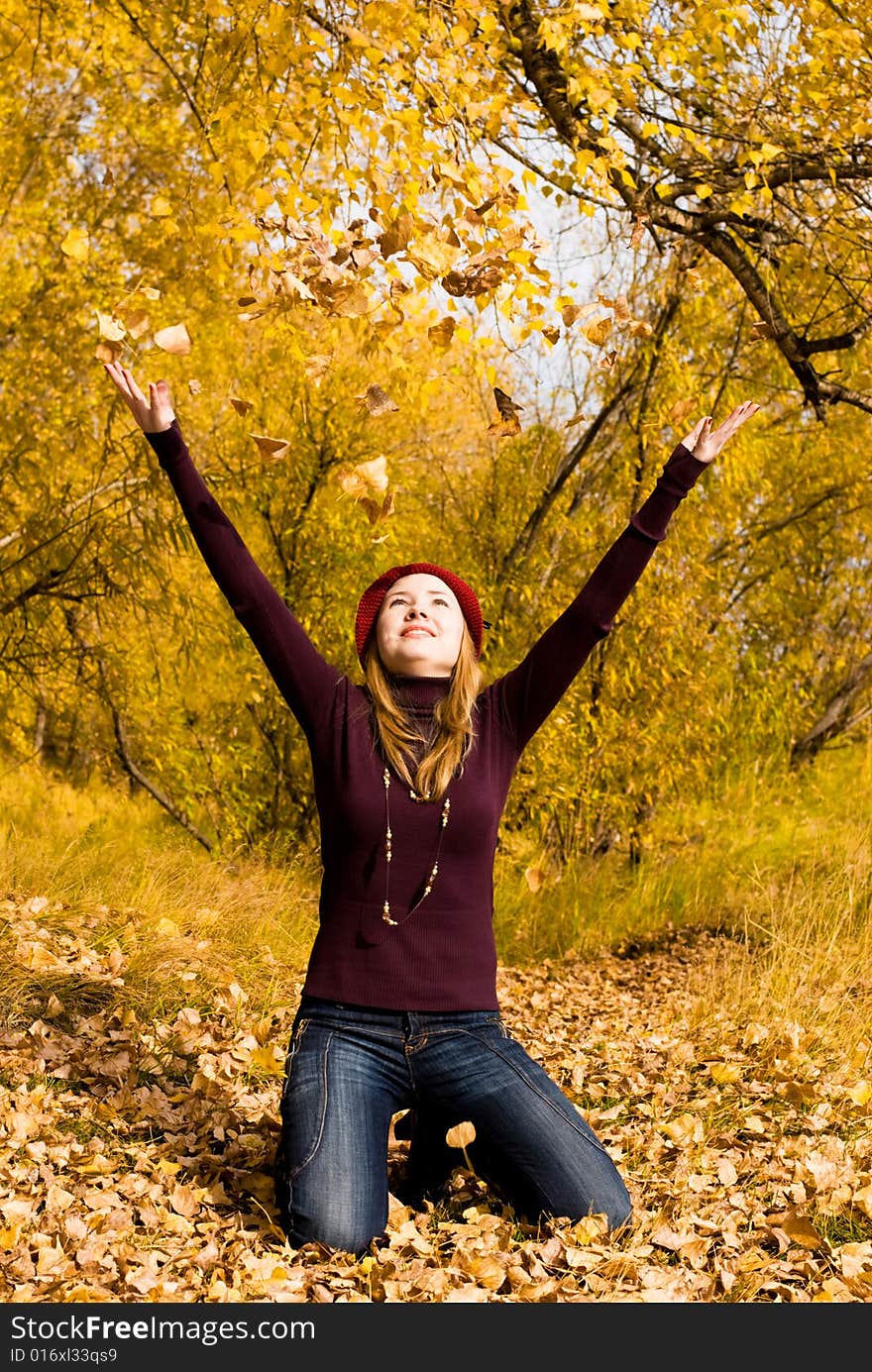 Happy girl throwing yellow leaves in the park. Happy girl throwing yellow leaves in the park