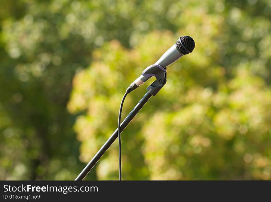 Microphone with stanchion on green background. Microphone with stanchion on green background