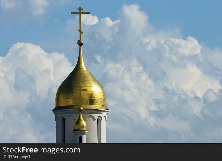 Gold church cupola on sky background