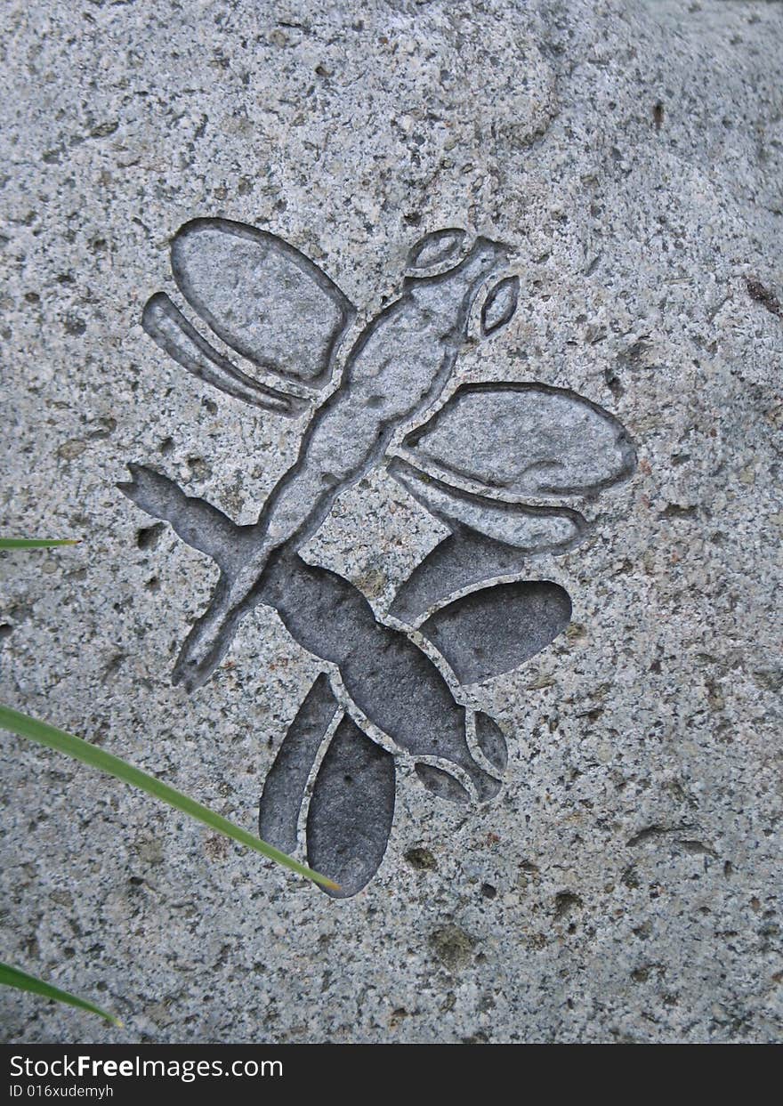 Dragonflies sculpted in a rock