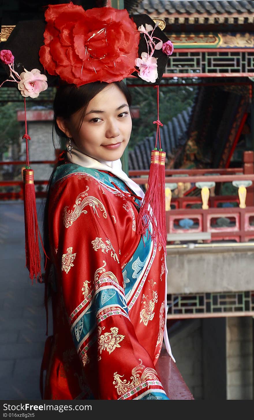 A girl in Chinese ancient dress stands in the attic in the royal garden. A girl in Chinese ancient dress stands in the attic in the royal garden.