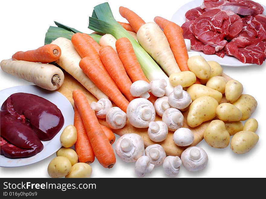 A selection of fresh meat and vegetables on a chopping board. A selection of fresh meat and vegetables on a chopping board.