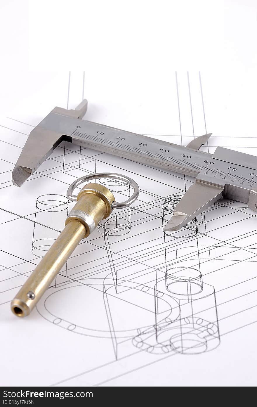 A pip-pin and calipers on a technical drawing with selective focus