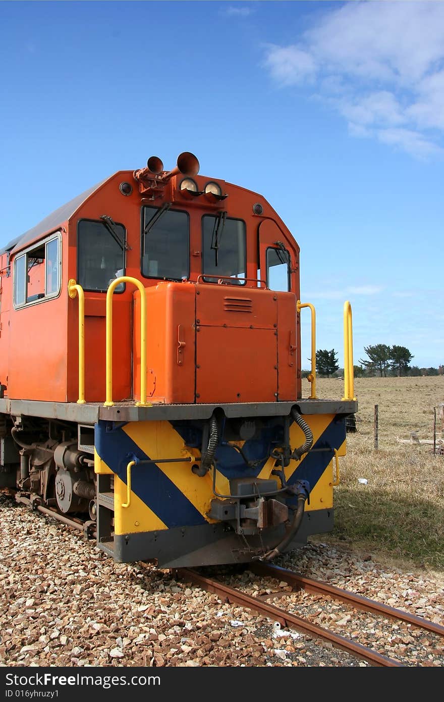 Orange train engine in the country side