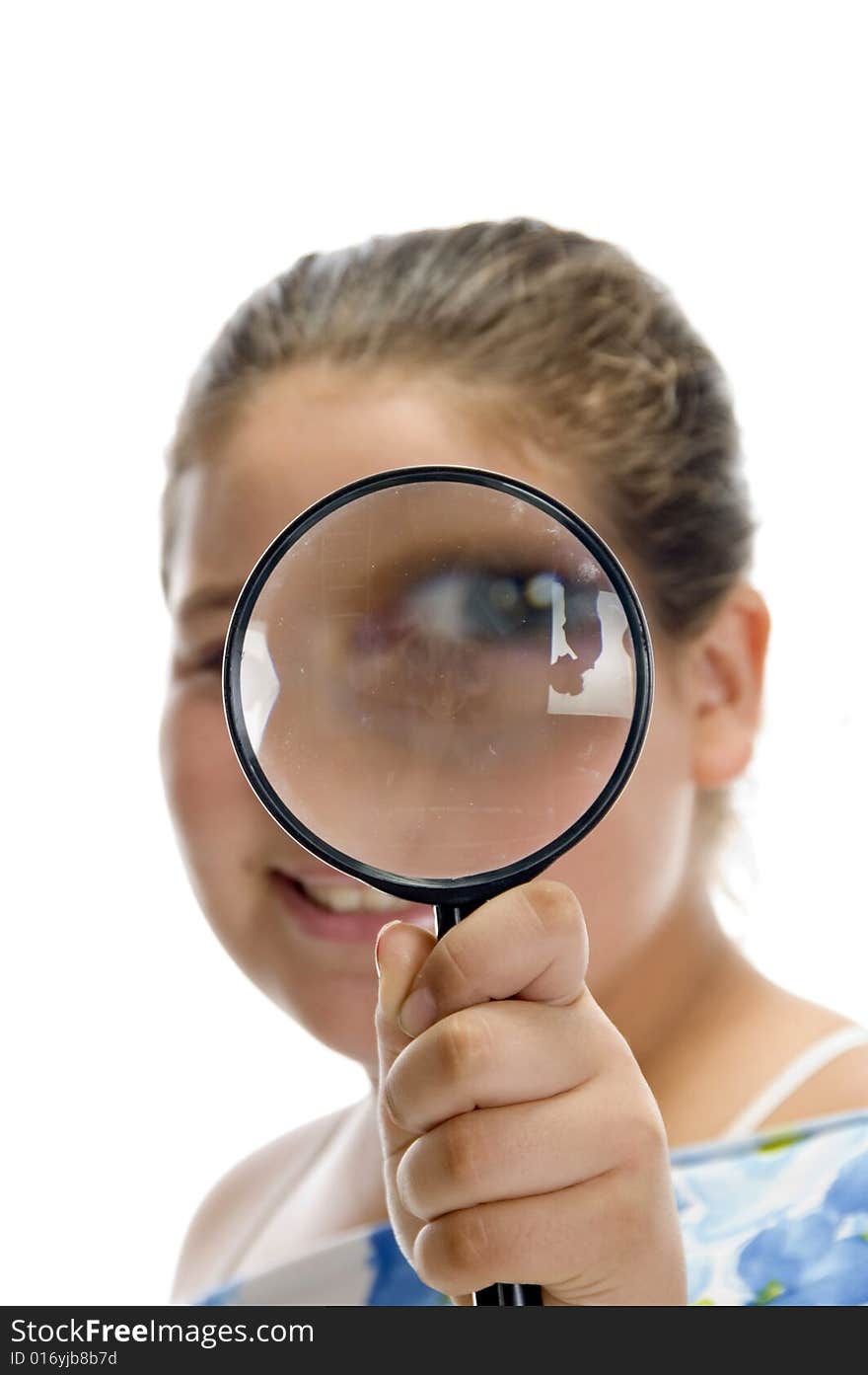 Girl looking through magnifier on an isolated background