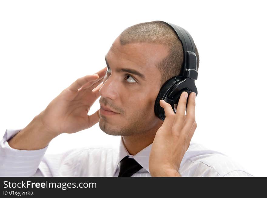 Man holding earphone and looking upward on an isolated background